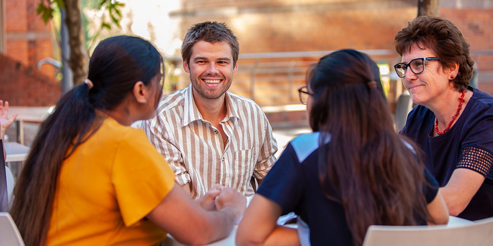 Group of people talking outdoors